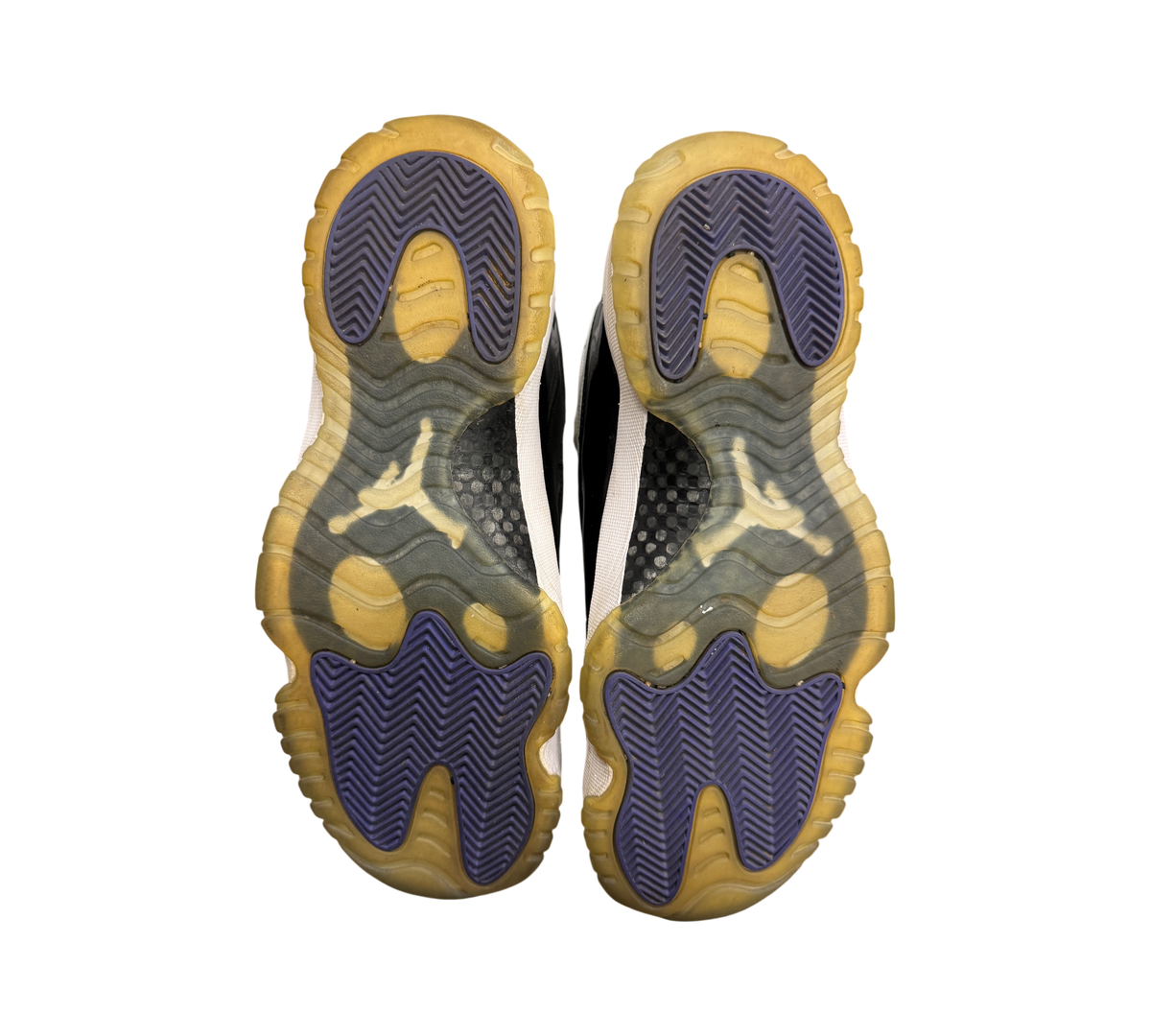 Genesis Boutique used Jordan 11 Concord sneakers showing the purple and yellowed translucent rubber outsoles