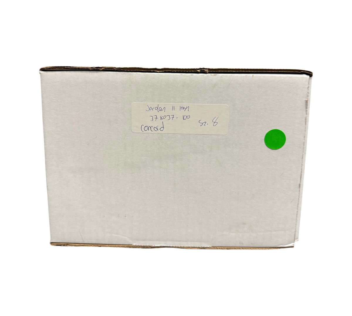 Genesis Boutique white cardboard shipping box with handwritten Jordan 11 Concord label and green sticker