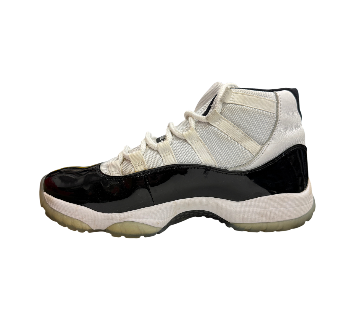 Genesis Boutique pre-owned Jordan 11 Concord sneaker in white and black patent leather with a translucent outsole.