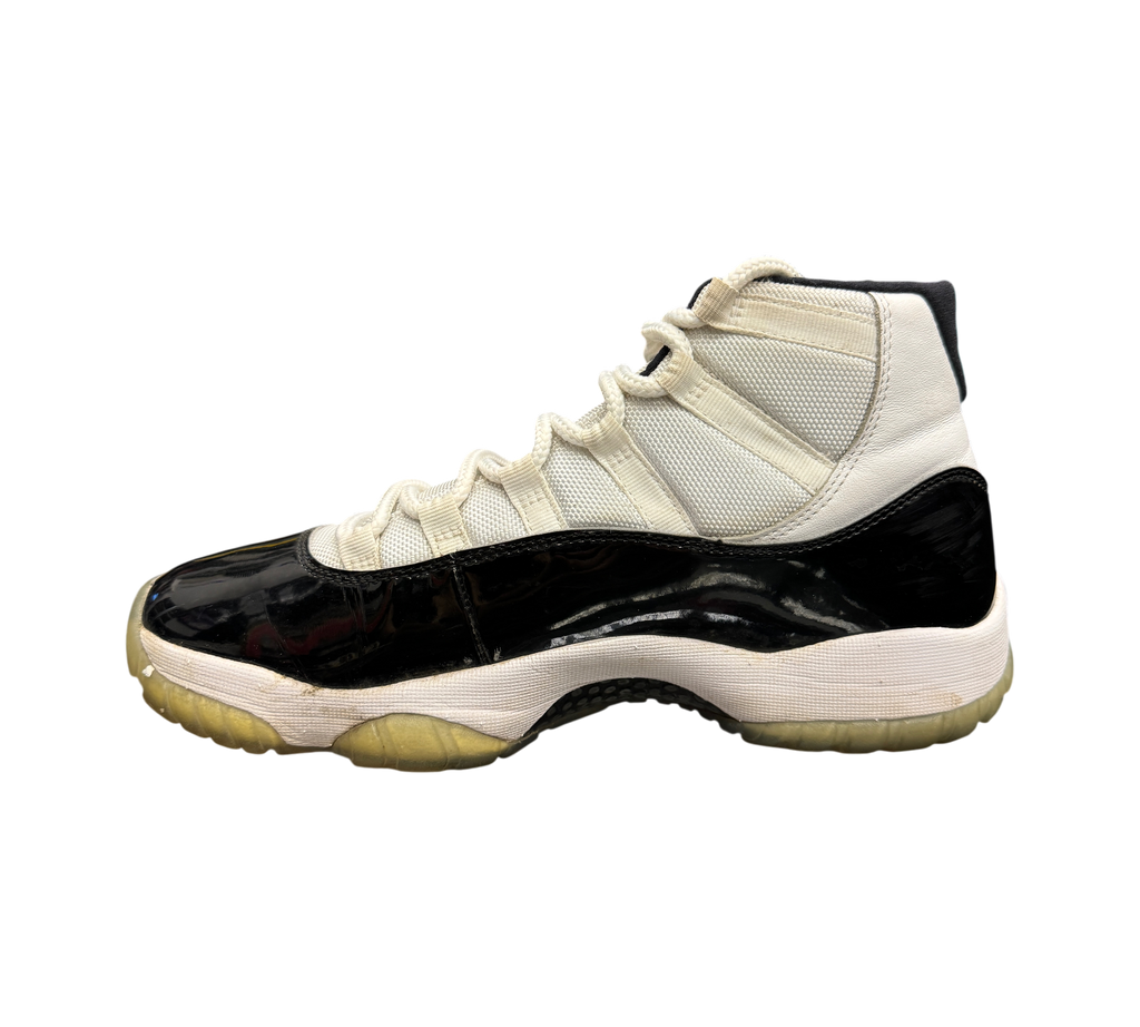 Genesis Boutique Jordan 11 Concord sneaker in white and black patent leather with a translucent yellowed outsole