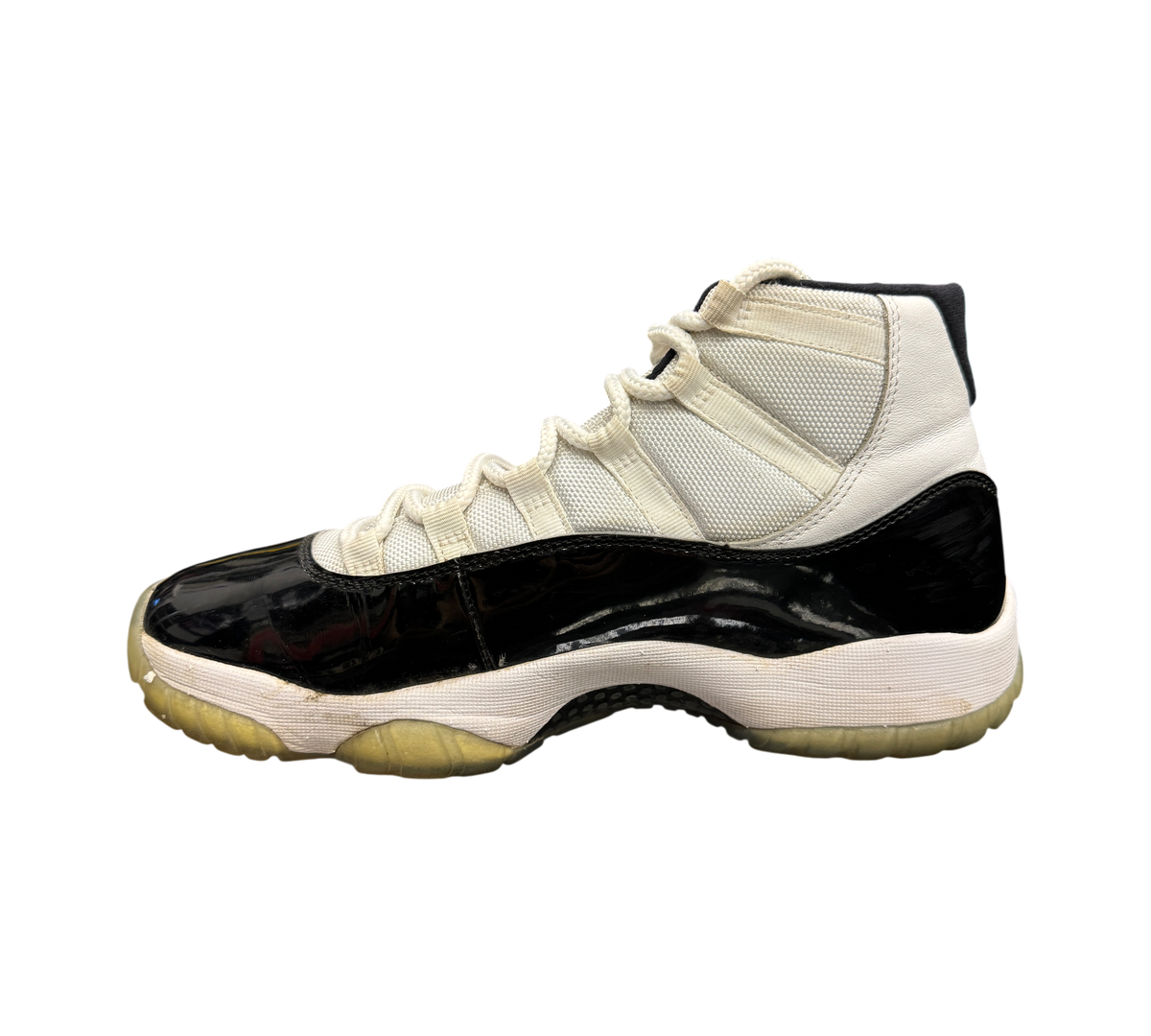 Genesis Boutique Jordan 11 Concord sneaker in white and black patent leather with a translucent yellowed outsole