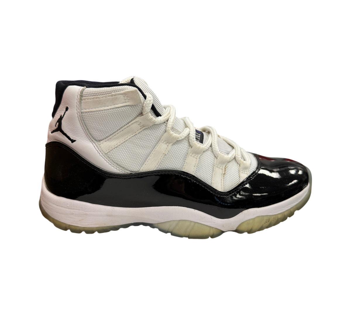 Genesis Boutique Jordan 11 Concord sneaker in white and black patent leather with a translucent outsole