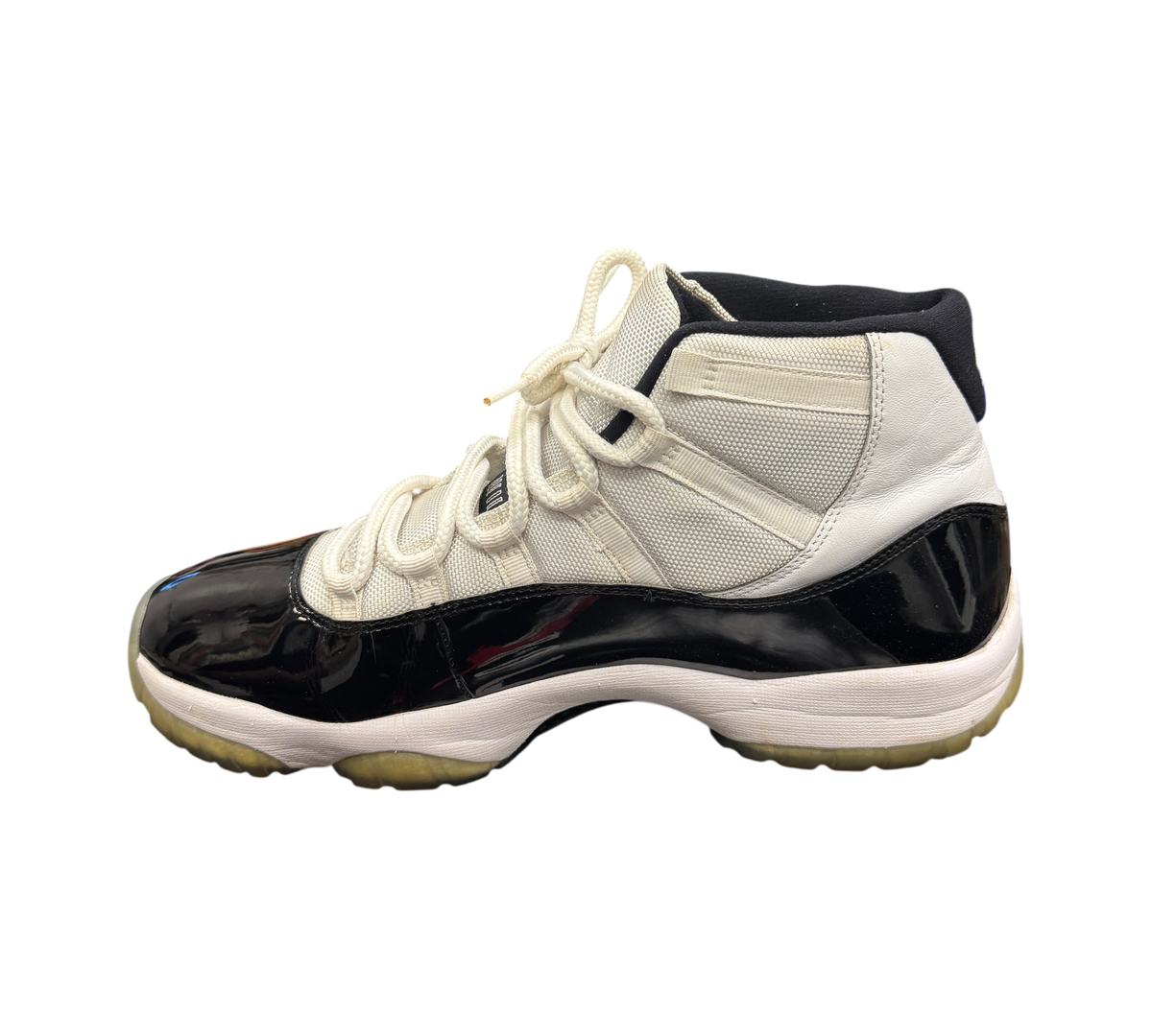Genesis Boutique Jordan 11 Concord sneaker in white and black patent leather with white laces on a Jordan shoe box