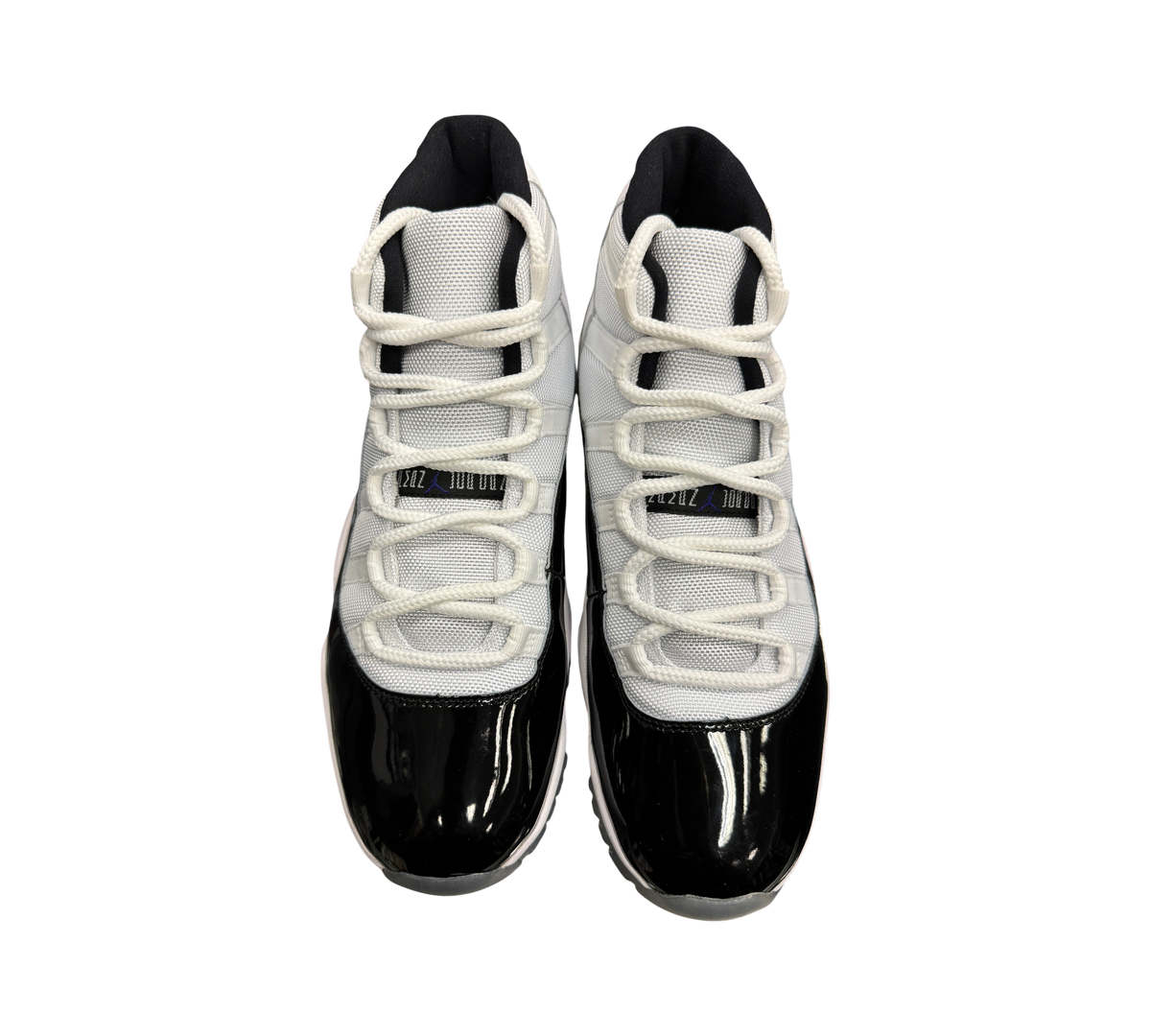 Genesis Boutique pre-owned Jordan 11 Concord sneakers featuring white mesh uppers and black patent leather mudguards.