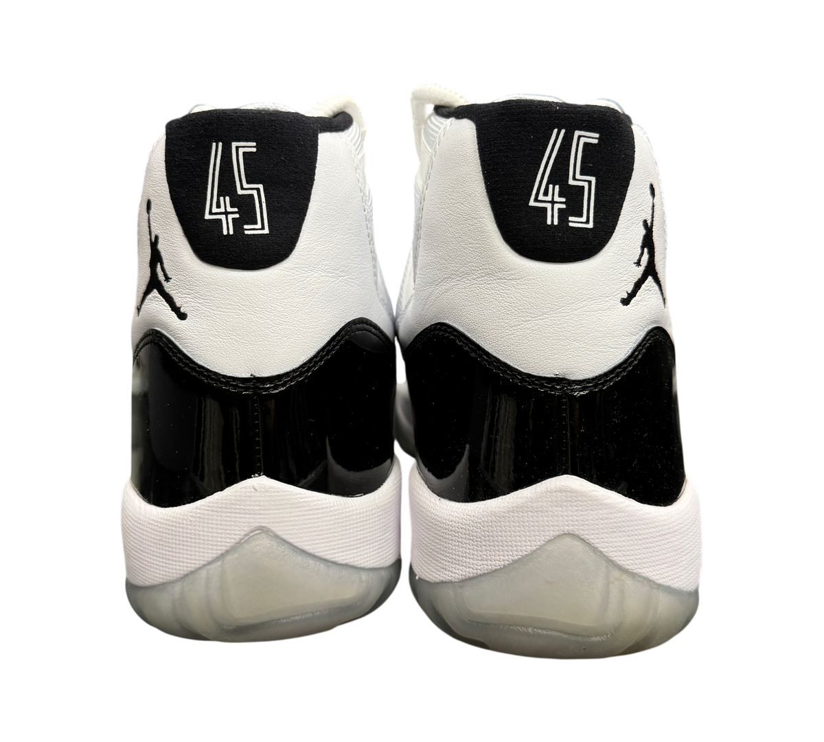 Genesis Boutique used Jordan 11 Concord sneakers featuring white leather, black patent leather, and number 45 heel detail.