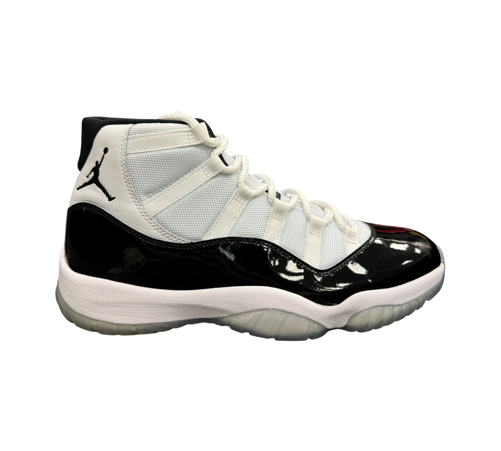 Genesis Boutique Jordan 11 Concord sneakers featuring white mesh upper, black patent leather mudguard, and icy outsole.