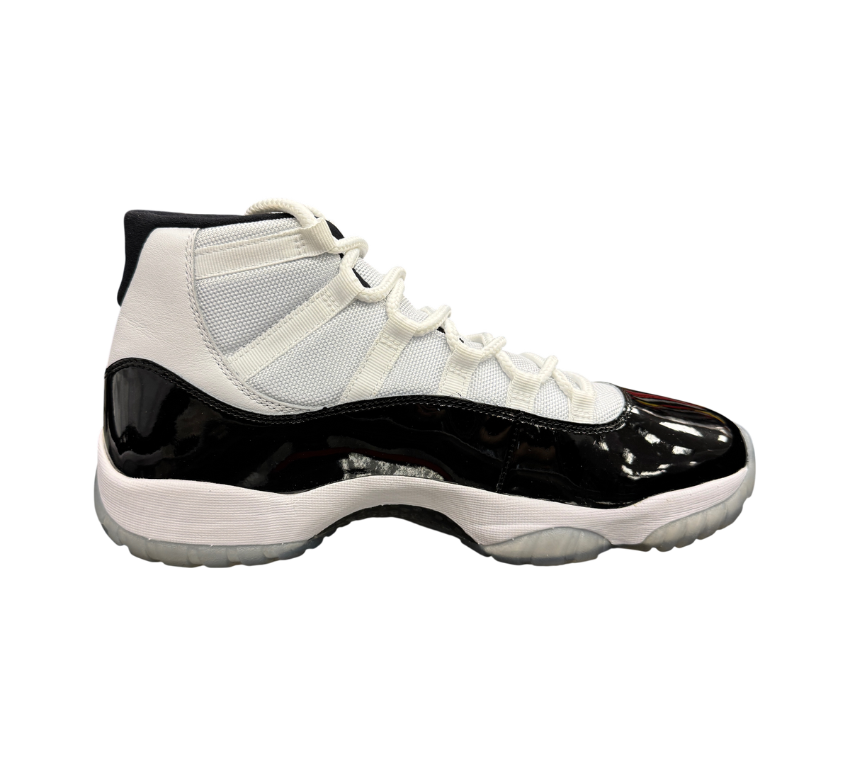 Genesis Boutique used Jordan 11 Concord sneakers featuring white mesh, black patent leather, and a translucent sole.