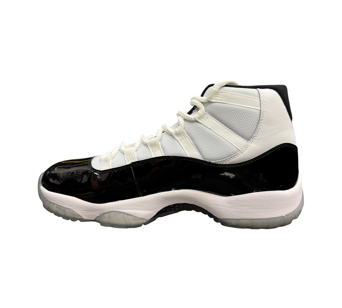 Genesis Boutique pre-owned Jordan 11 Concord sneakers featuring white mesh, black patent leather, and icy outsoles.