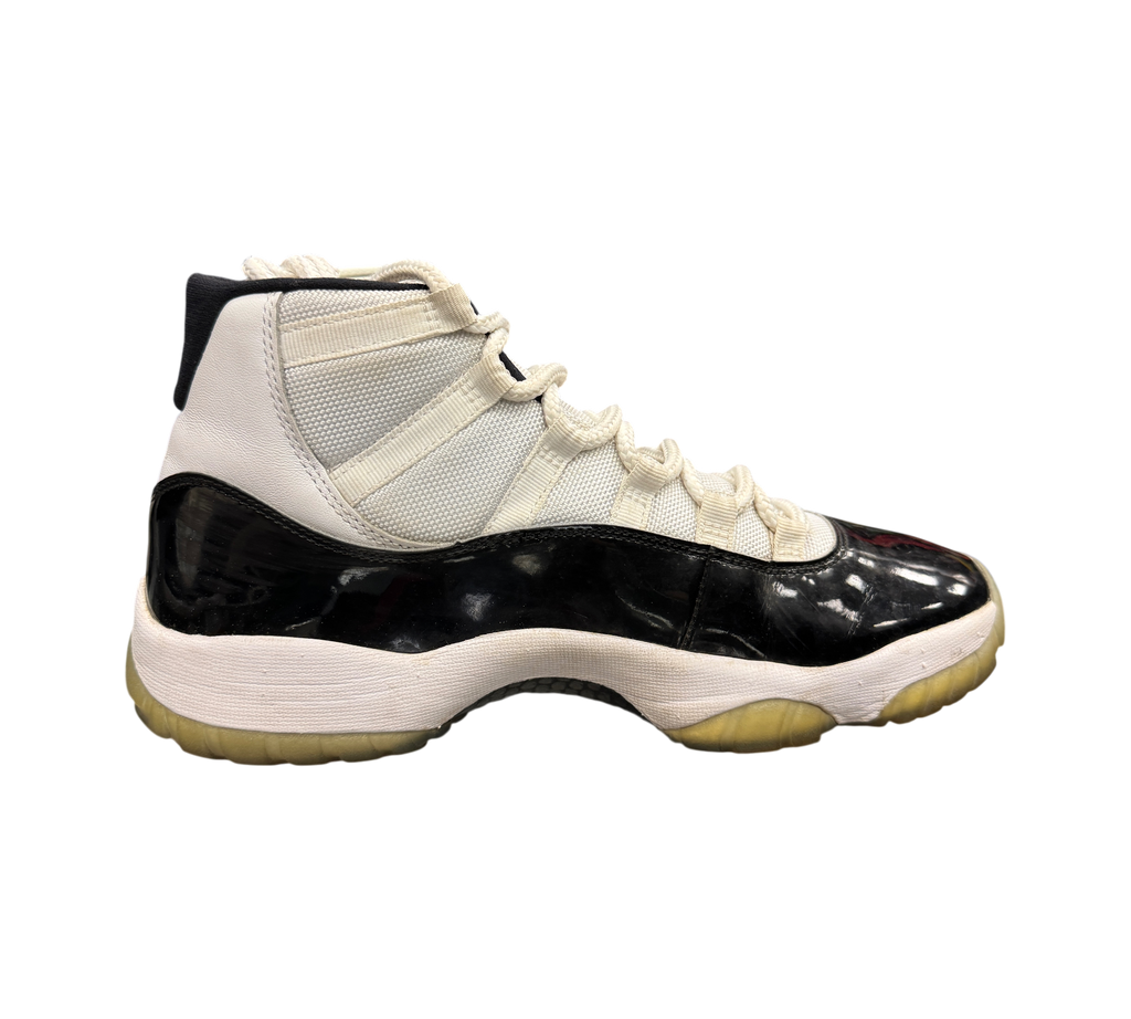 Genesis Boutique Jordan 11 Concord sneakers featuring white mesh upper, black patent leather mudguard, and icy outsole.