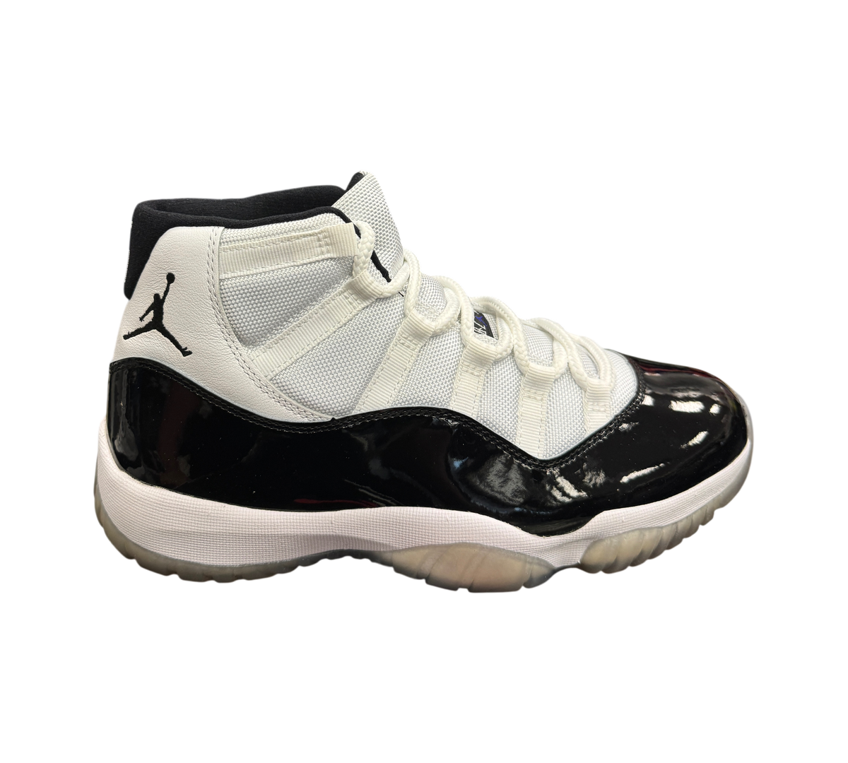 Genesis Boutique Jordan 11 Concord sneakers featuring white mesh, black patent leather mudguard, and translucent sole.