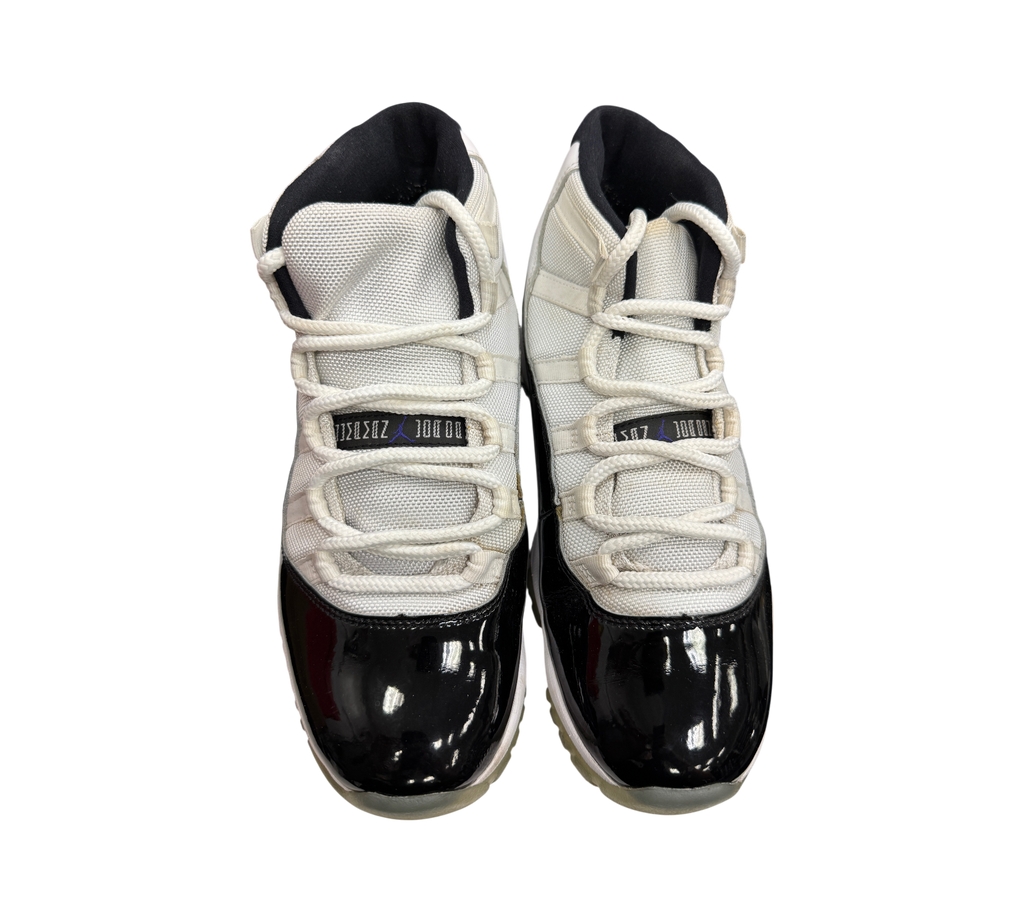 Genesis Boutique pre-owned Jordan 11 Concord sneakers featuring white mesh uppers and black patent leather mudguards.