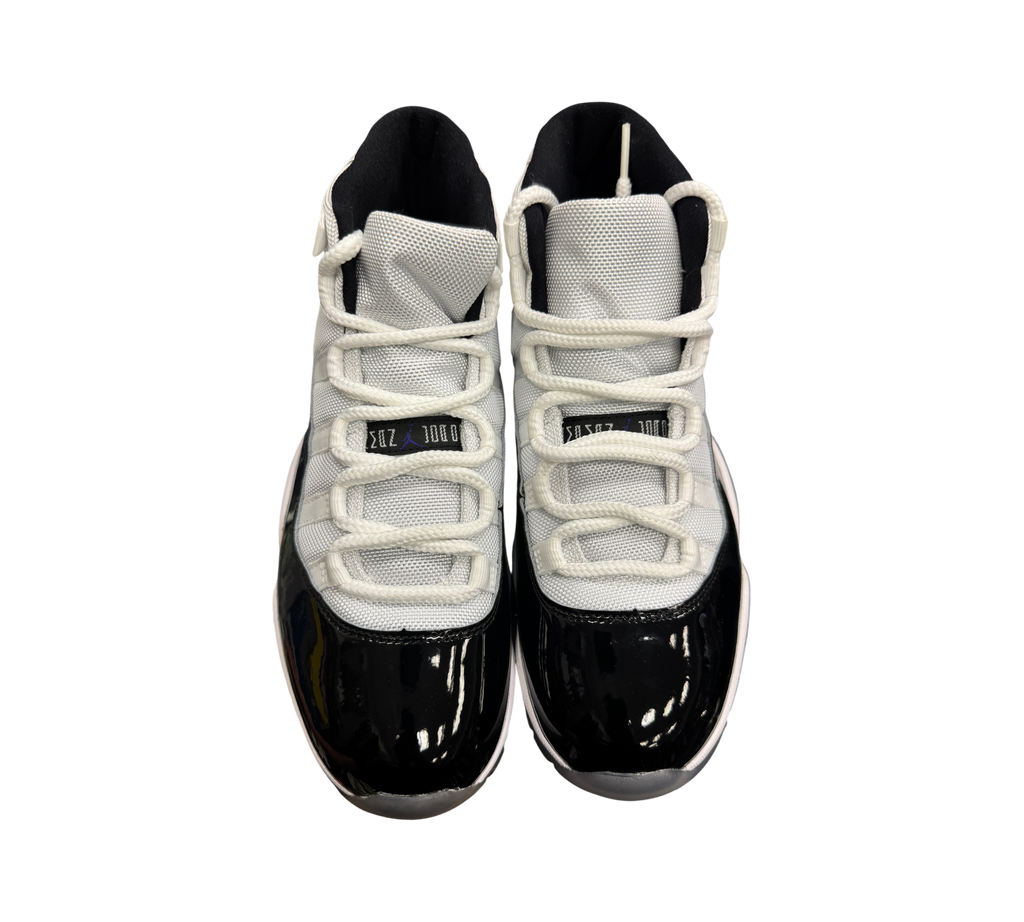 Genesis Boutique Jordan 11 Concord sneakers featuring white mesh uppers and black patent leather mudguards