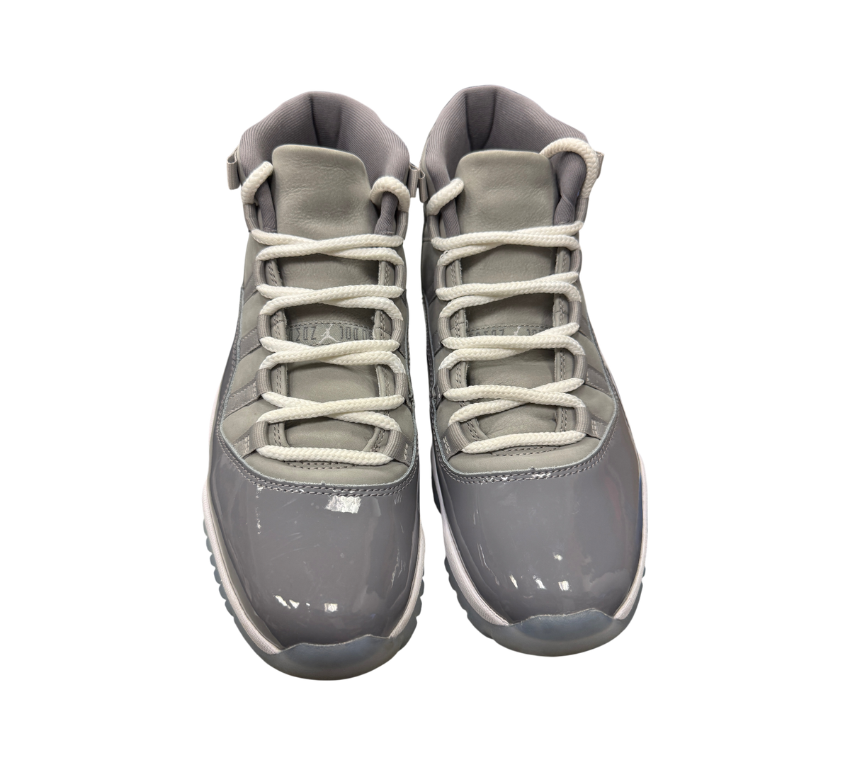 Genesis Boutique pre-owned Jordan 11 Cool Grey sneakers featuring grey patent leather and white laces.