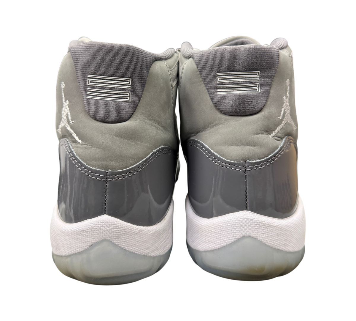 Back view of used Genesis Boutique Jordan 11 Cool Grey sneakers featuring grey nubuck, patent leather, and Jumpman logo.