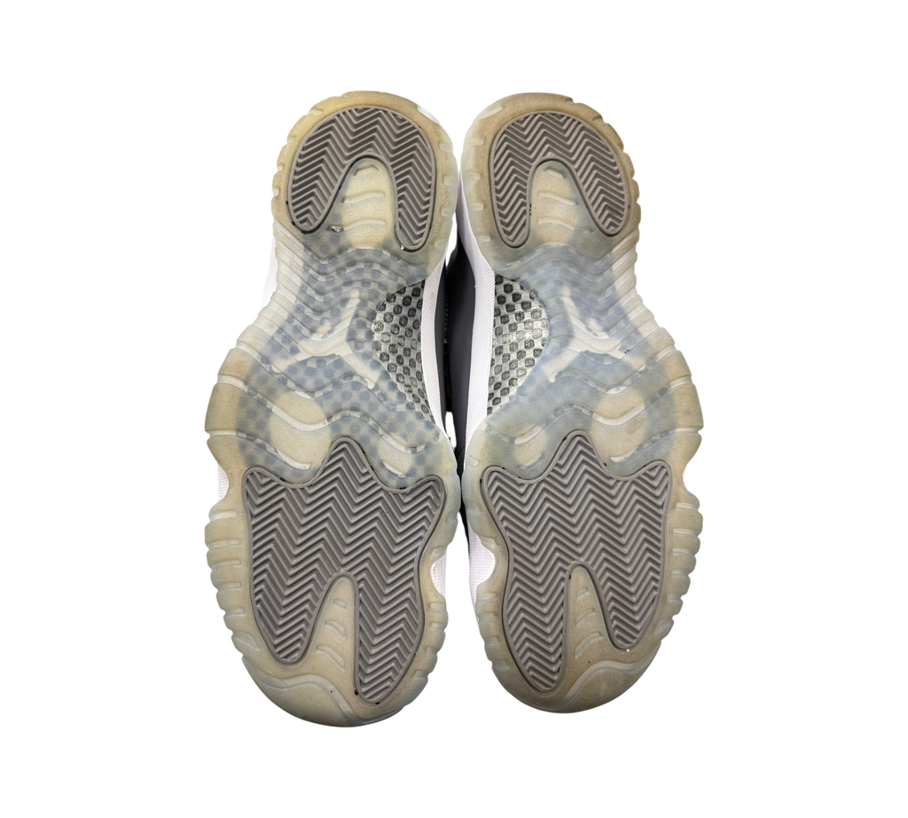 Genesis Boutique used Jordan 11 Cool Grey sneakers showing the grey and translucent herringbone traction outsoles.