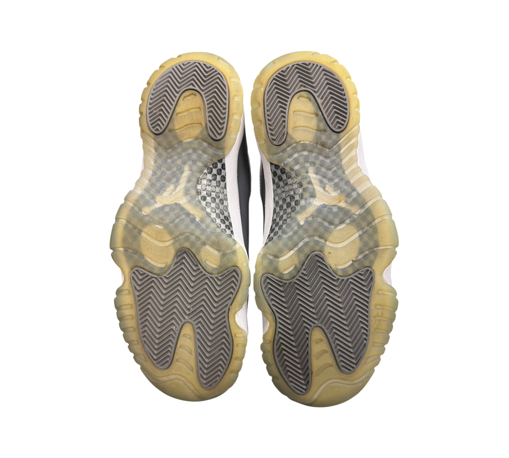 Genesis Boutique used Jordan 11 Cool Grey sneakers showing the yellowed translucent rubber outsoles and carbon fiber