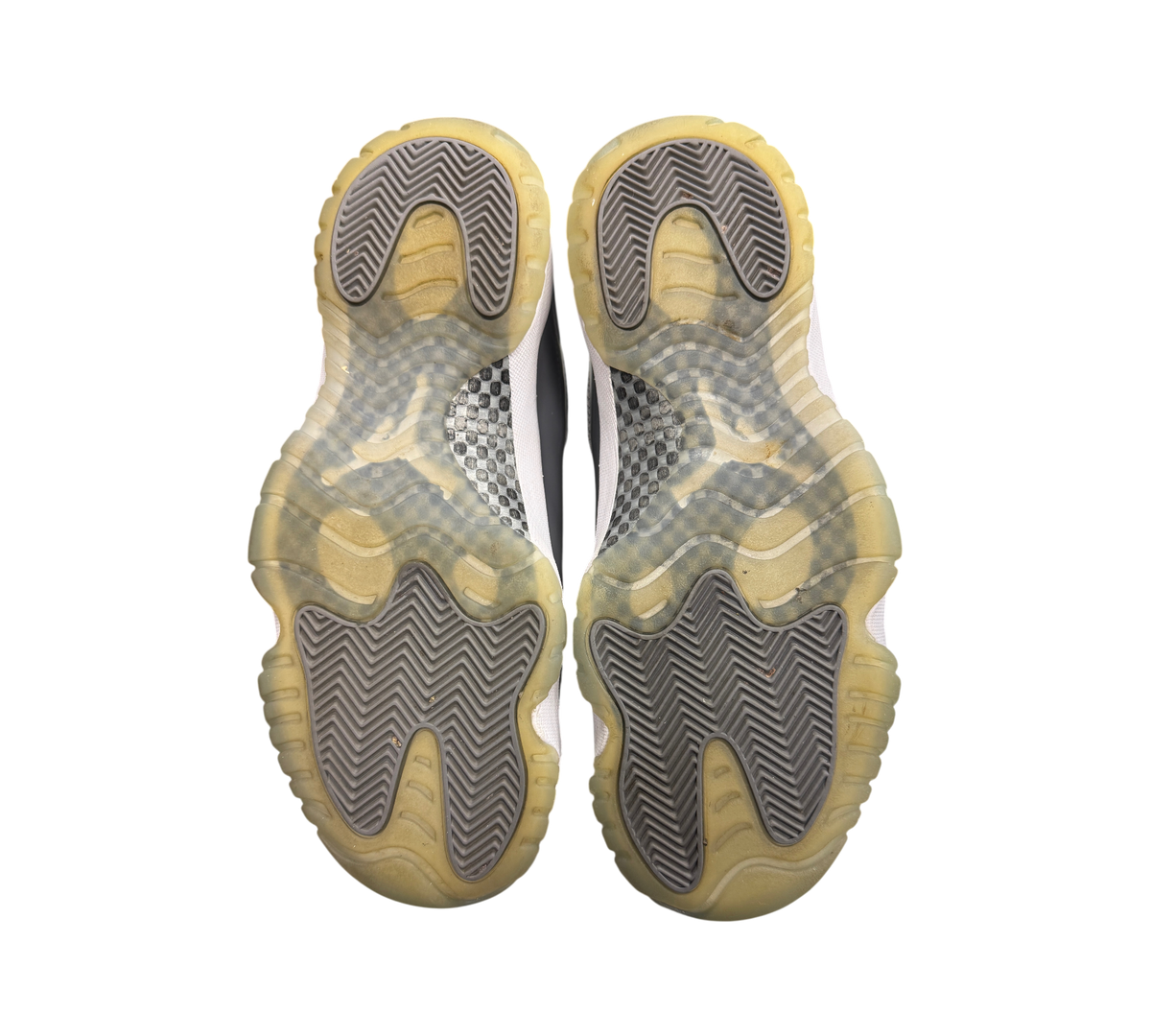 Genesis Boutique used Jordan 11 Cool Grey sneakers showing the yellowed translucent rubber outsoles and carbon fiber