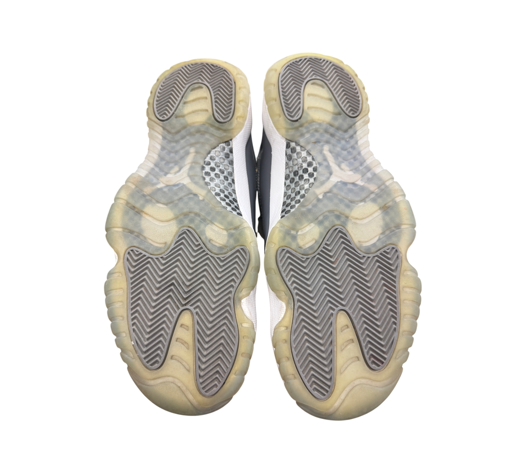 Genesis Boutique used Jordan 11 Cool Grey sneakers showing the translucent grey rubber outsoles with traction pattern