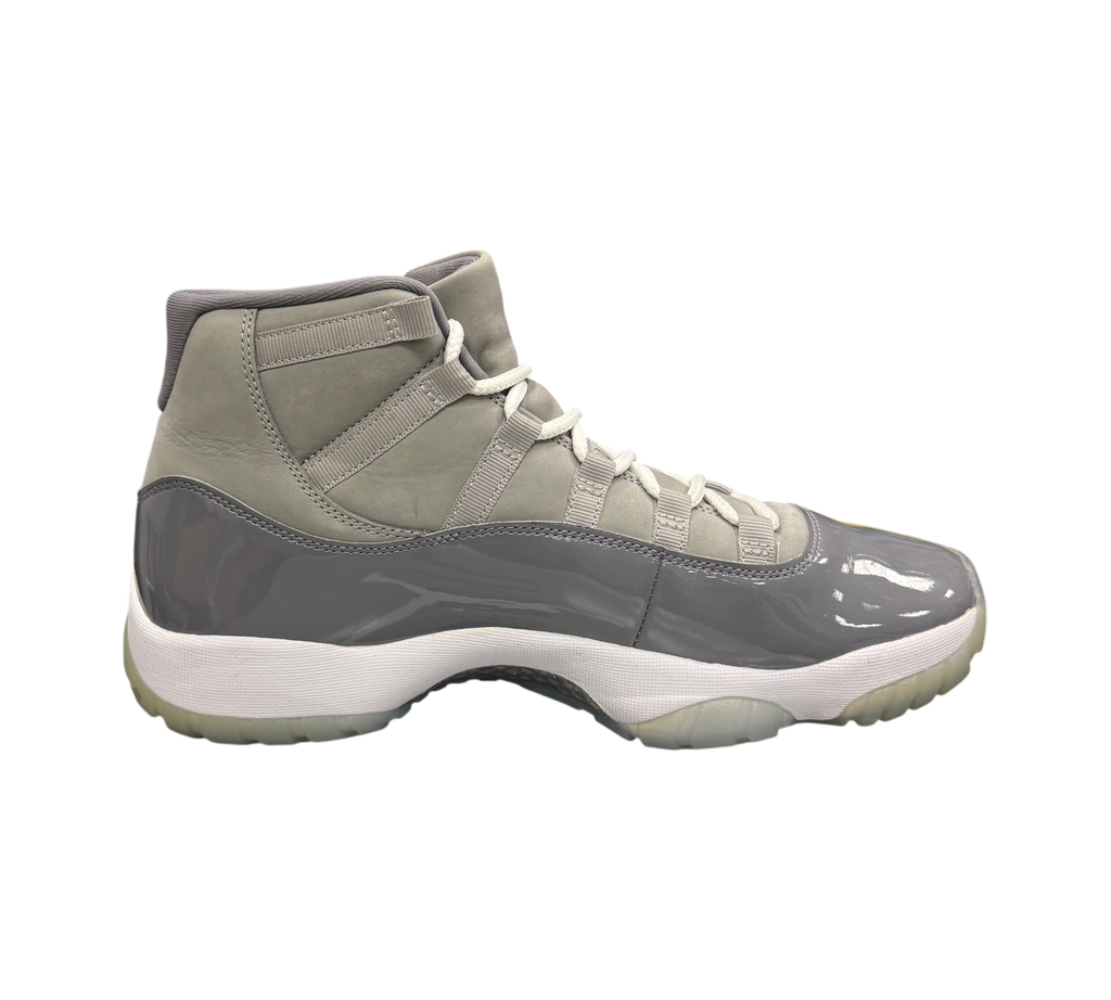 Genesis Boutique Jordan 11 Cool Grey sneakers featuring a grey patent leather mudguard and suede upper with white laces