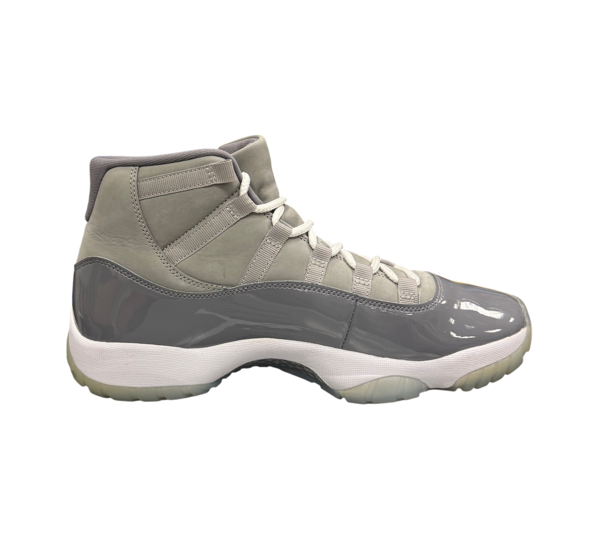 Genesis Boutique Jordan 11 Cool Grey sneakers featuring a grey patent leather mudguard and suede upper with white laces
