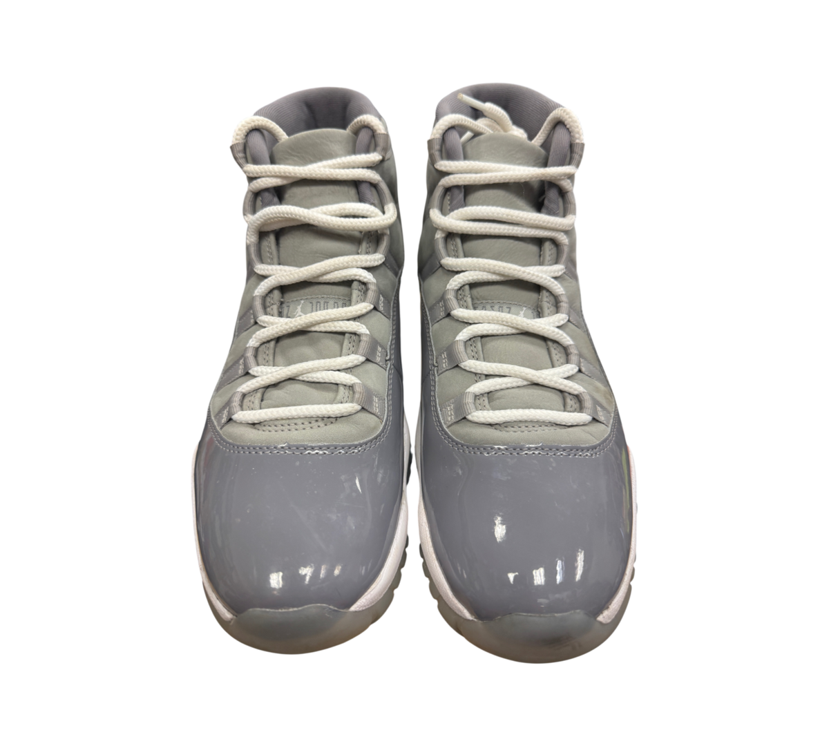Genesis Boutique Jordan 11 Cool Grey sneakers featuring grey patent leather and nubuck with white laces