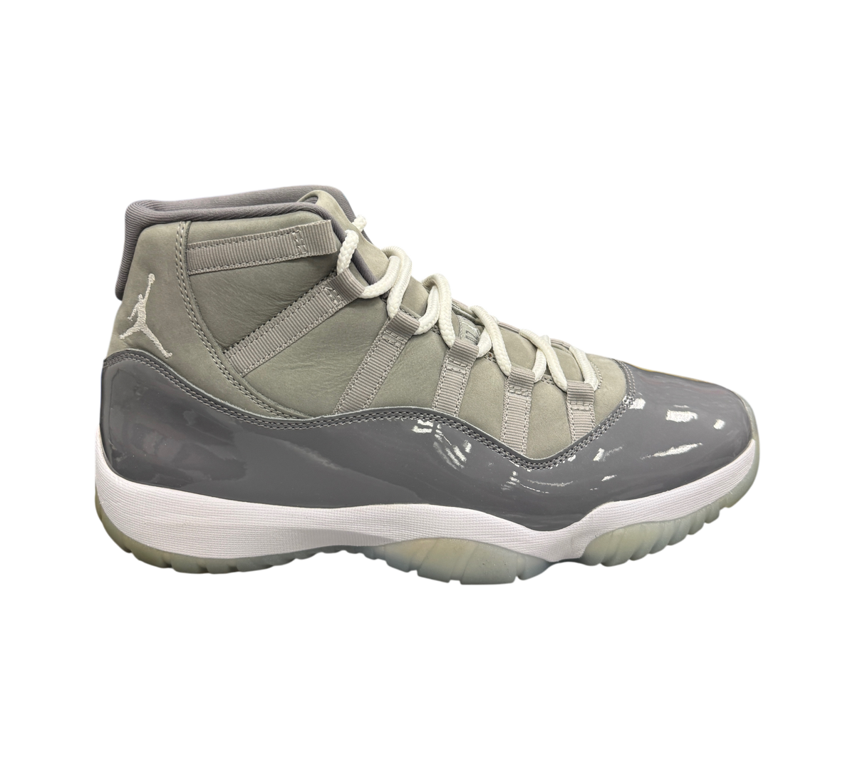 Genesis Boutique Jordan 11 Cool Grey sneakers featuring a grey patent leather mudguard and white midsole.