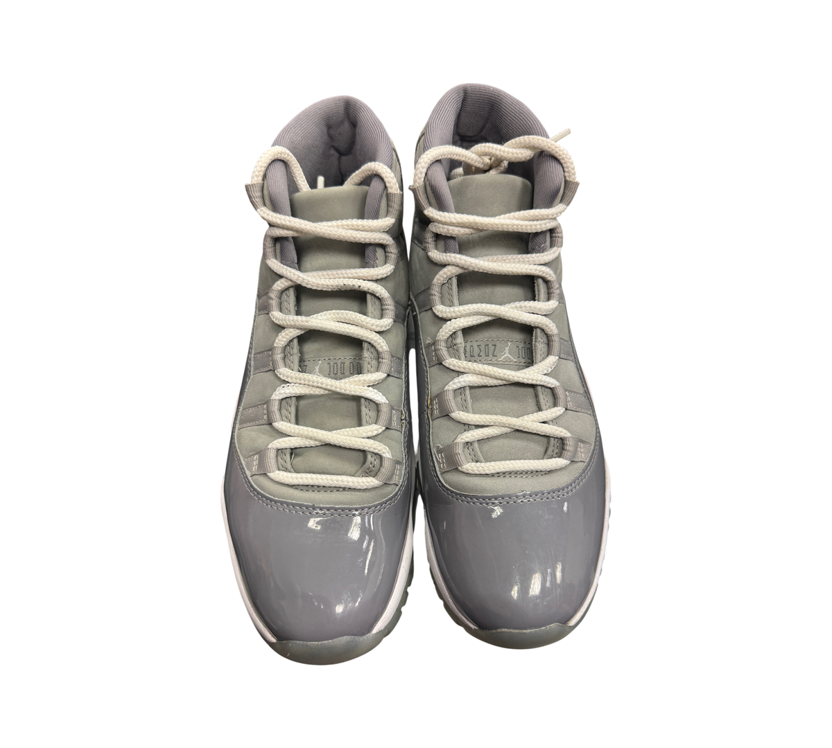Genesis Boutique Jordan 11 Cool Grey sneakers featuring grey patent leather and mesh upper with white laces