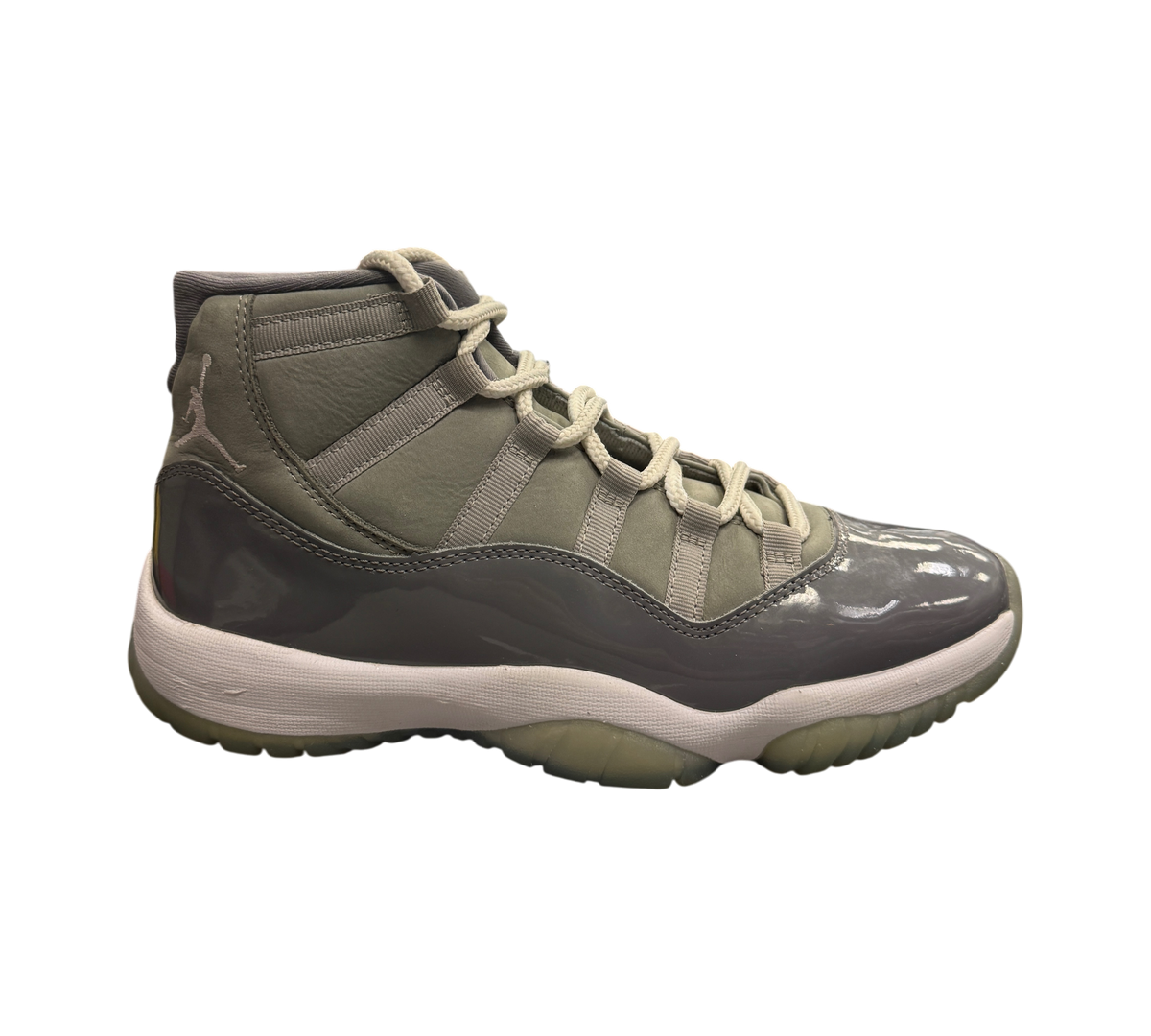 Genesis Boutique Jordan 11 Cool Grey sneakers featuring a grey nubuck upper and glossy patent leather mudguard.