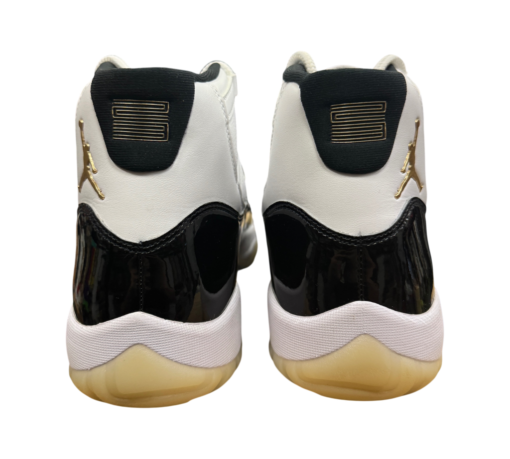 Genesis Boutique Jordan 11 DMP Gratitude sneakers featuring white leather, black patent leather, and gold Jumpman logo.