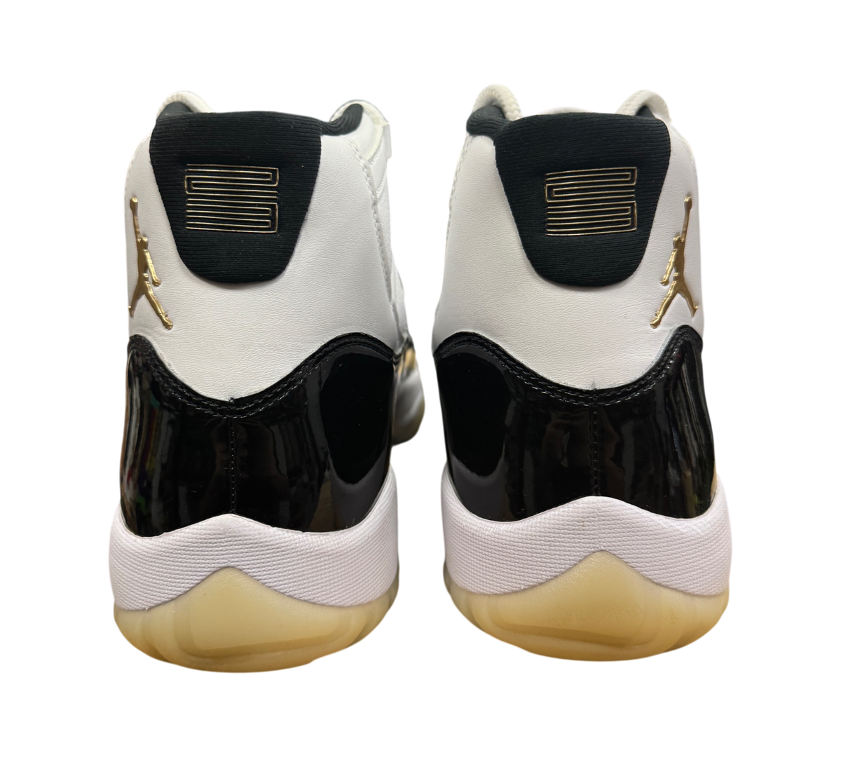 Genesis Boutique Jordan 11 DMP Gratitude sneakers featuring white leather, black patent leather, and gold Jumpman logo.