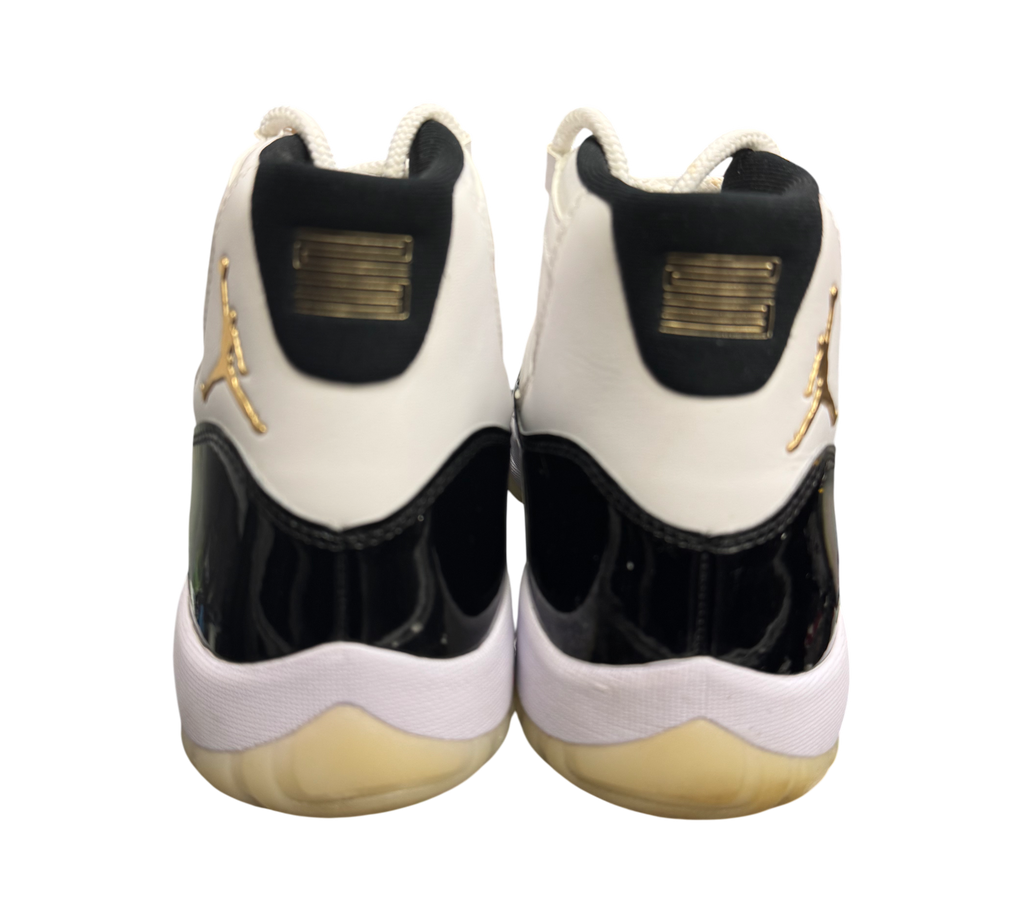 Genesis Boutique Jordan 11 DMP Gratitude sneakers with white, black, and gold accents. Patent leather details.
