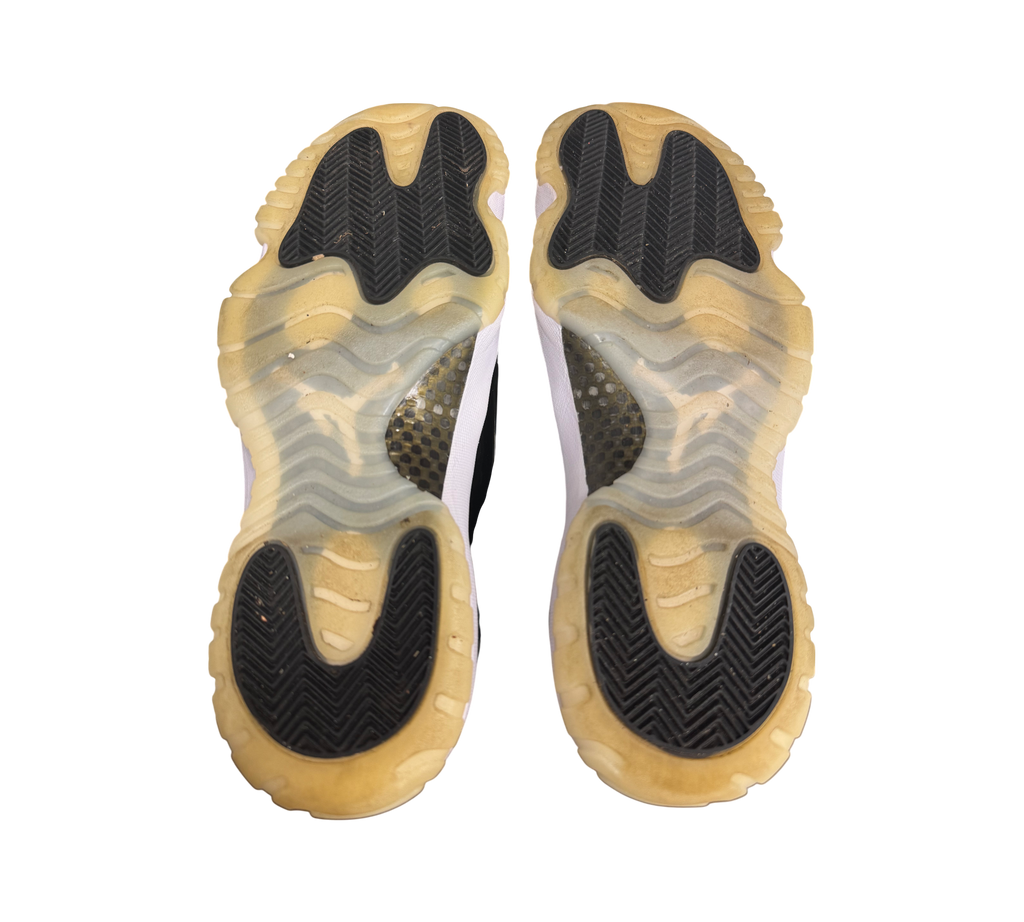Genesis Boutique Jordan 11 DMP Gratitude sneakers, showing the translucent yellowed soles with black traction pods.