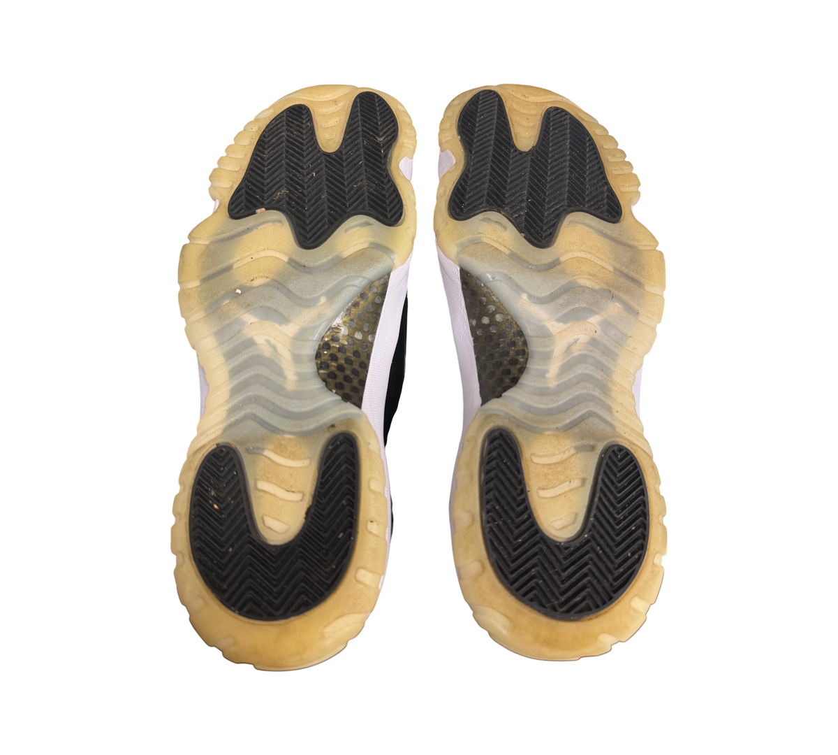 Genesis Boutique Jordan 11 DMP Gratitude sneakers, showing the translucent yellowed soles with black traction pods.