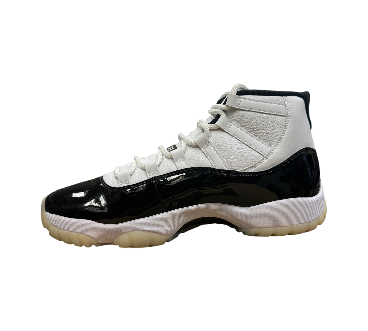 Genesis Boutique Jordan 11 DMP Gratitude sneakers featuring white leather upper and black patent leather mudguard