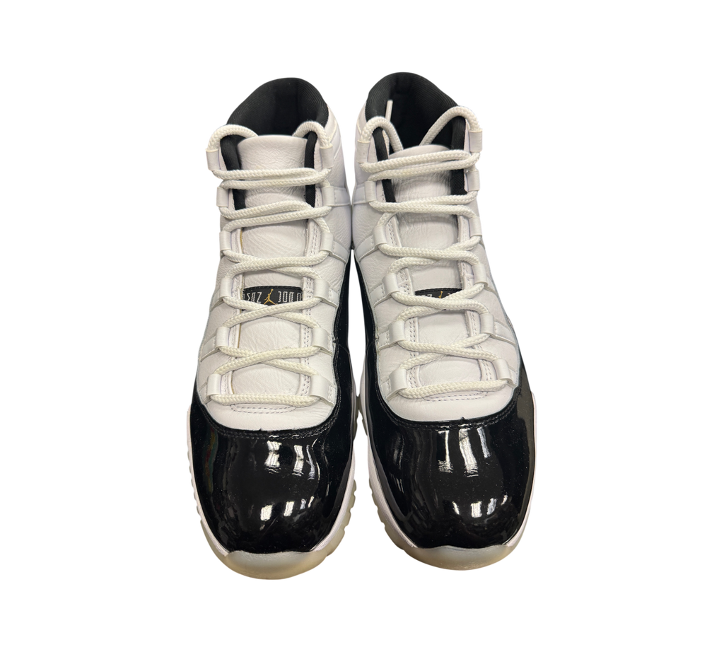 Genesis Boutique Jordan 11 DMP Gratitude sneakers featuring a white leather upper and black patent leather mudguard.