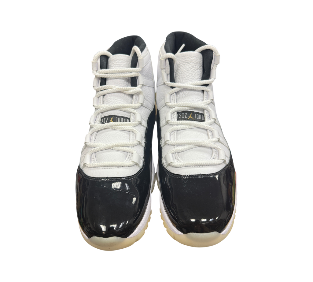 Genesis Boutique Jordan 11 DMP Gratitude sneakers featuring white leather uppers and black patent leather mudguards.