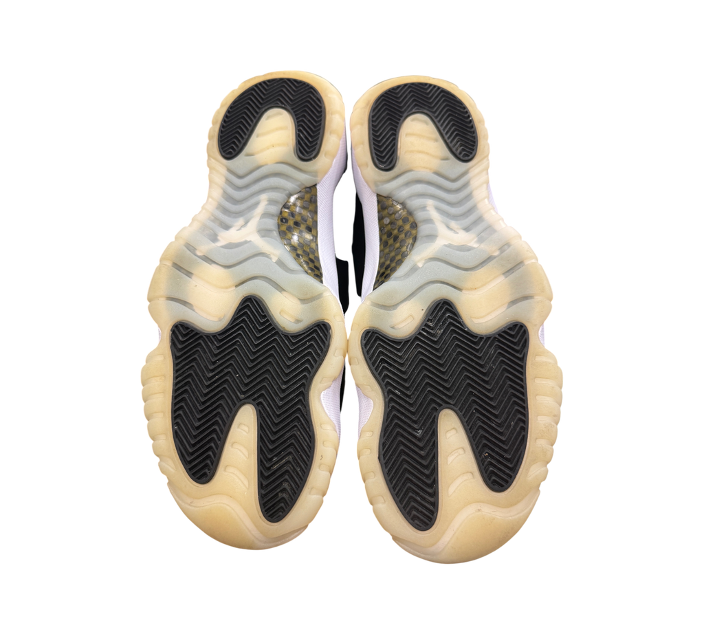 Genesis Boutique Jordan 11 DMP Gratitude sneakers showing the black and translucent yellowed rubber outsoles