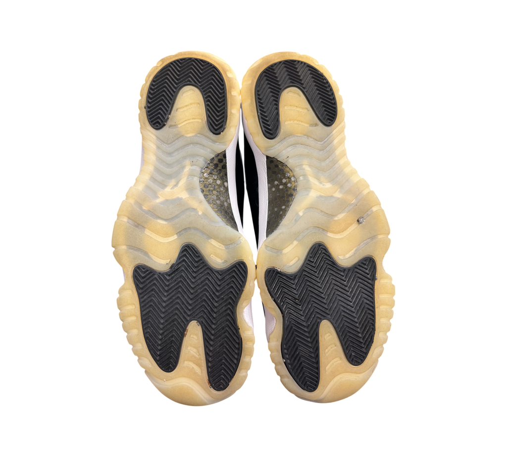 Genesis Boutique Jordan 11 DMP Gratitude sneakers showing the black and translucent yellowed rubber outsoles