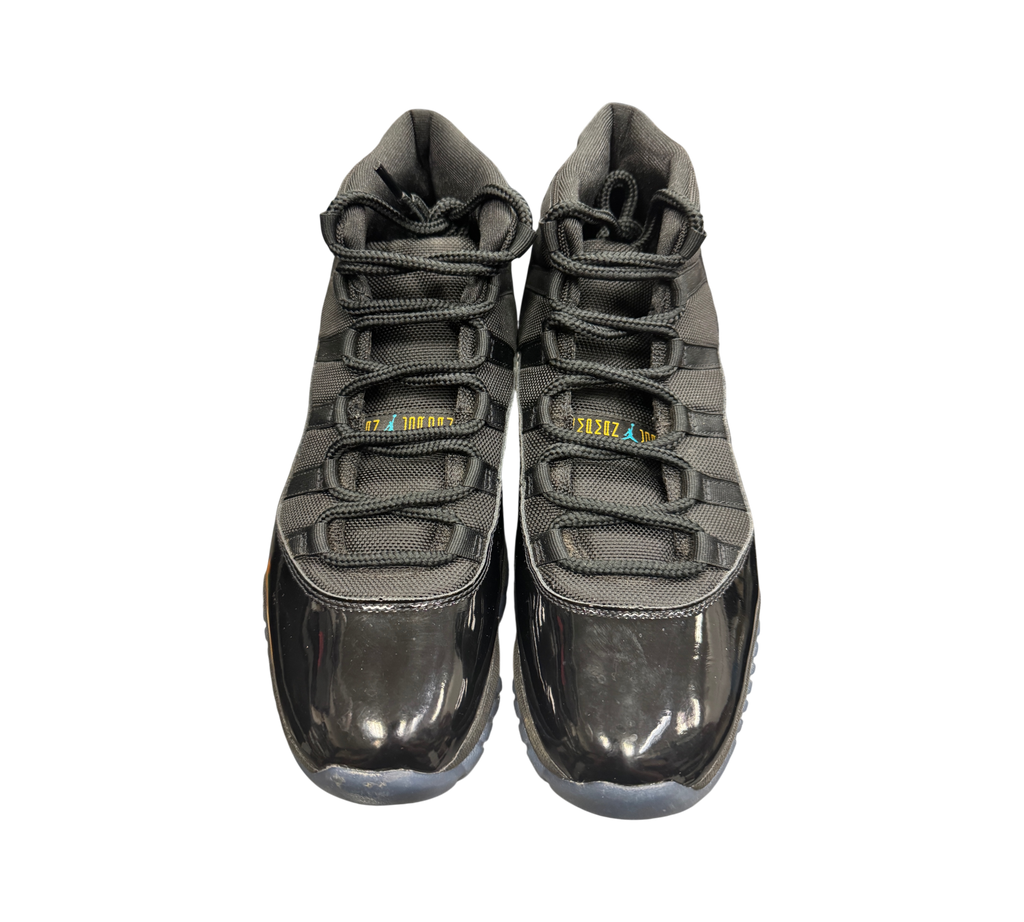 Genesis Boutique Jordan 11 Gamma sneakers in black with patent leather mudguards and blue and yellow tongue branding