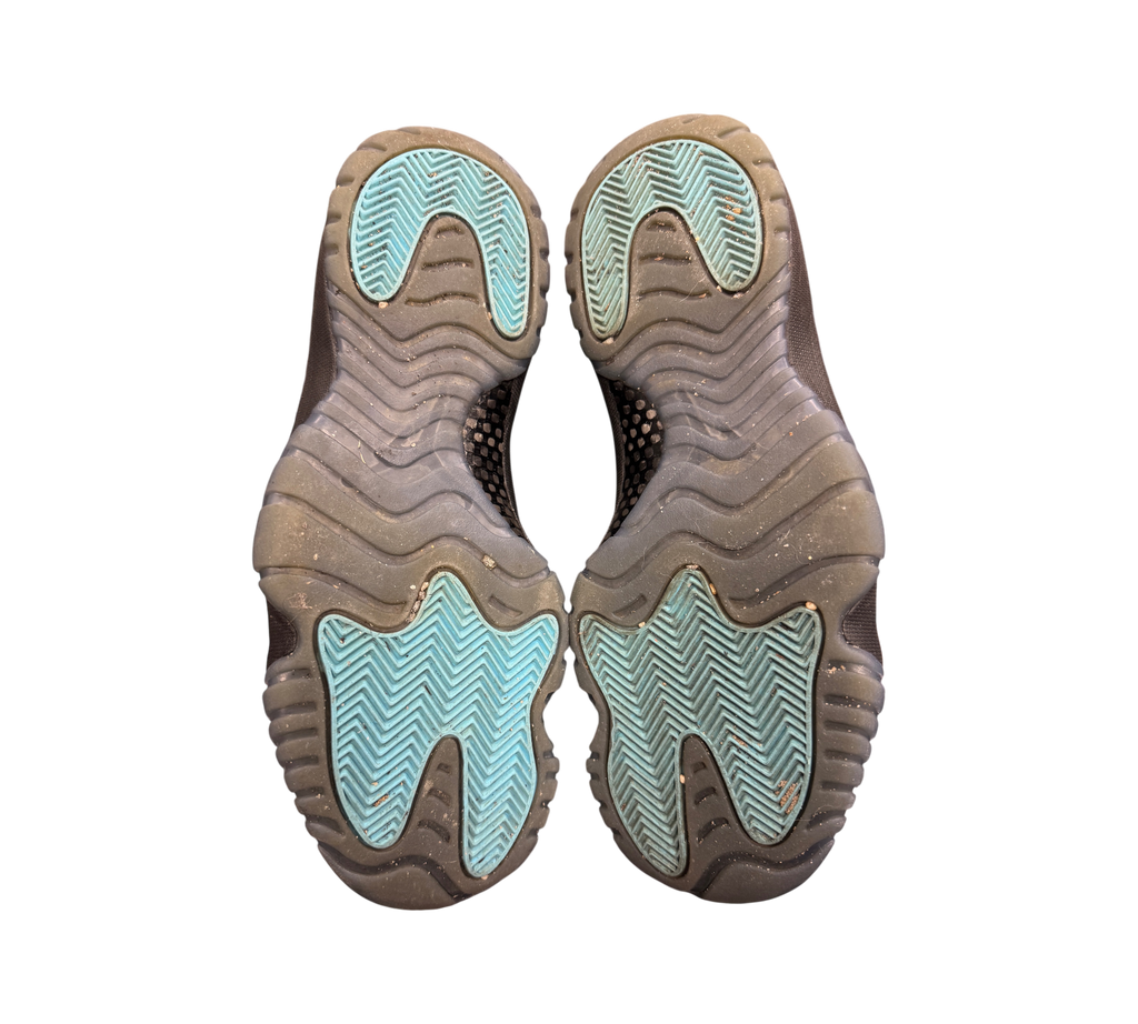 Genesis Boutique used Jordan 11 Gamma sneakers showing the black and blue translucent rubber outsoles