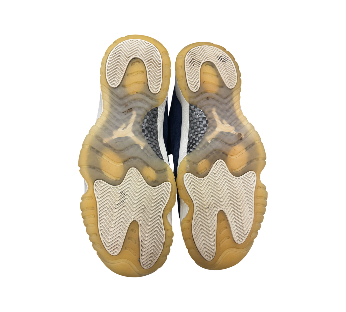 Genesis Boutique Jordan 11 Derek Jeter RE2PECT sneakers showing the translucent gum rubber outsoles and carbon fiber