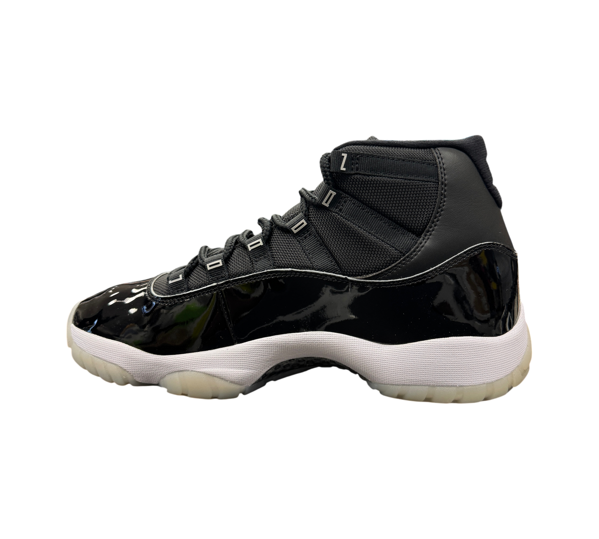 Genesis Boutique Jordan 11 Jubilee sneaker in black patent leather and mesh with a white midsole and translucent sole