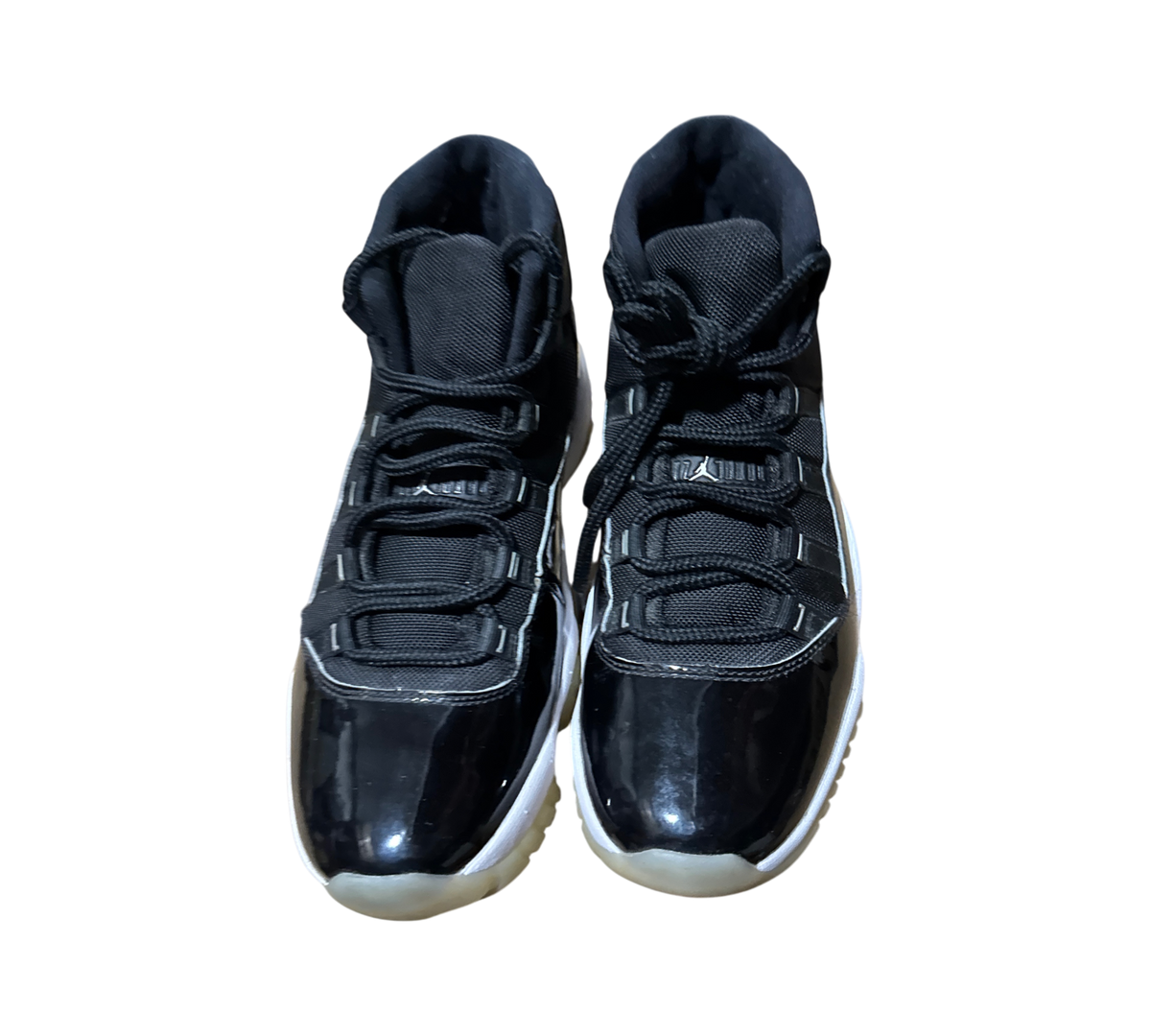 Genesis Boutique Jordan 11 Jubilee sneakers in black patent leather with white midsoles and translucent outsoles