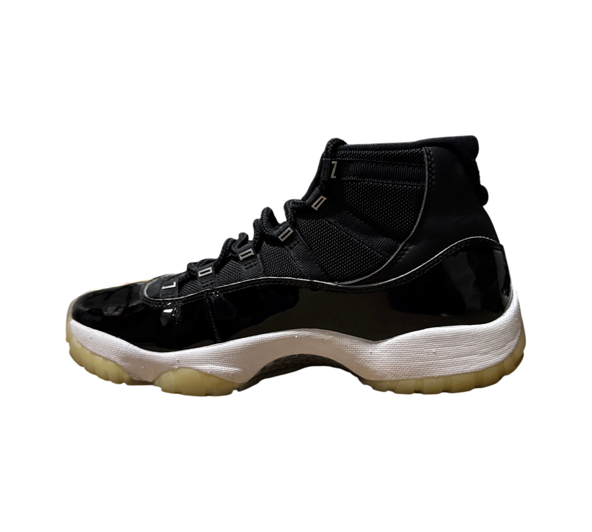 Genesis Boutique Jordan 11 Jubilee sneakers in black patent leather with a white midsole and translucent outsole.