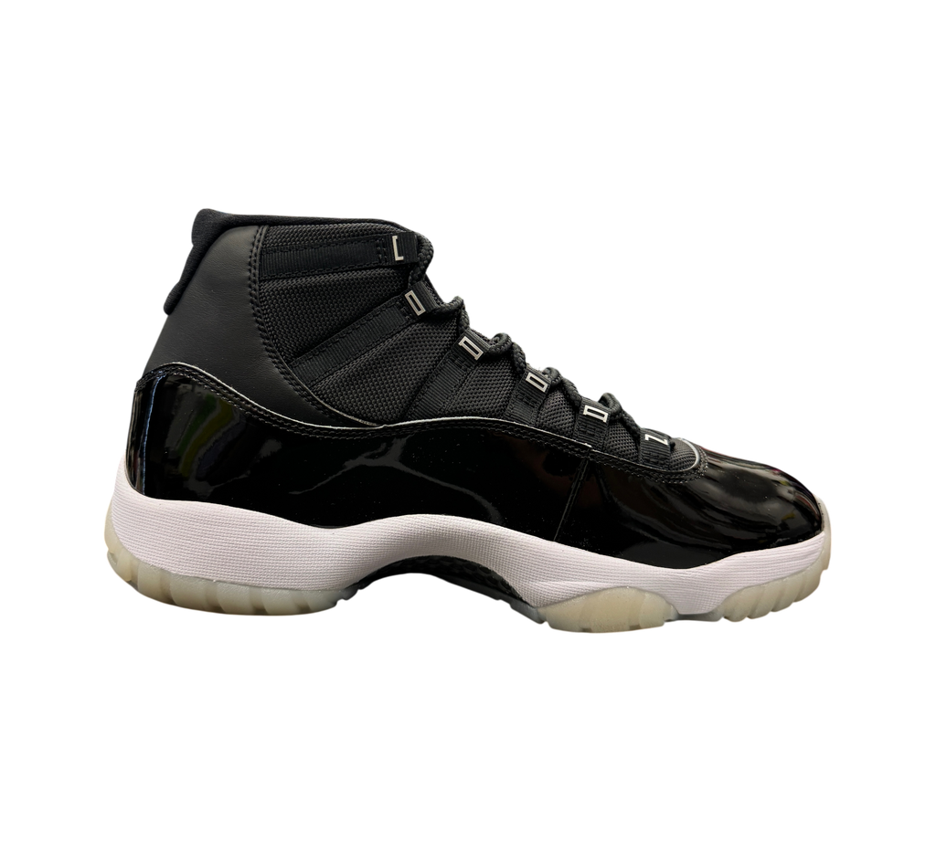 Genesis Boutique Jordan 11 Jubilee sneakers in black patent leather and mesh with a white midsole and translucent sole.