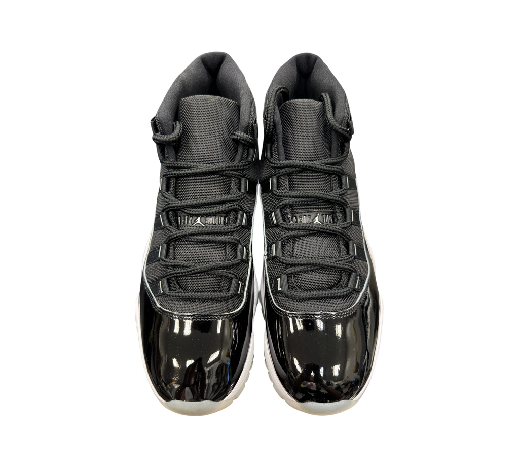 Genesis Boutique Jordan 11 Jubilee sneakers in black with patent leather mudguards and white midsoles, top view.