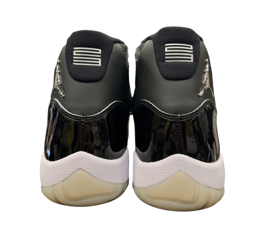 Genesis Boutique Jordan 11 Jubilee sneakers showing the black patent leather heels and silver Jumpman logos.