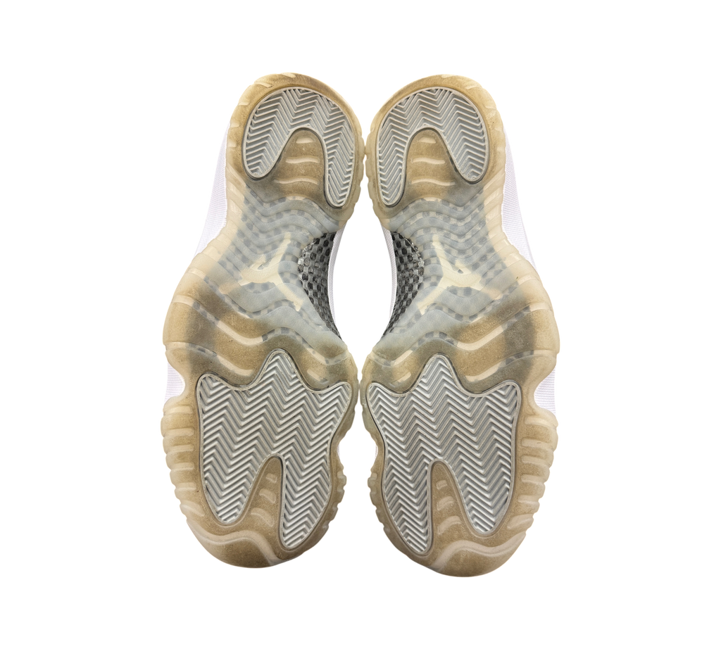 Genesis Boutique Jordan 11 Jubilee sneakers showing the translucent rubber outsoles with herringbone traction pattern