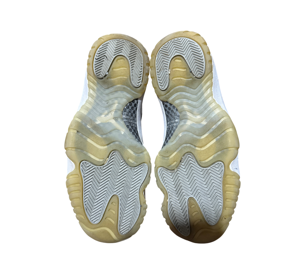 Genesis Boutique Jordan 11 Jubilee sneakers showing the translucent rubber outsoles with herringbone traction pattern