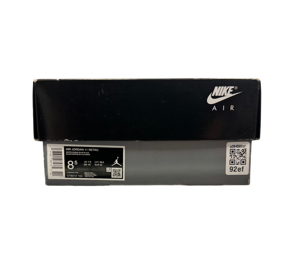 Genesis Boutique Jordan 11 Legend Blue sneaker box with Nike Air branding and size label on a glass display counter